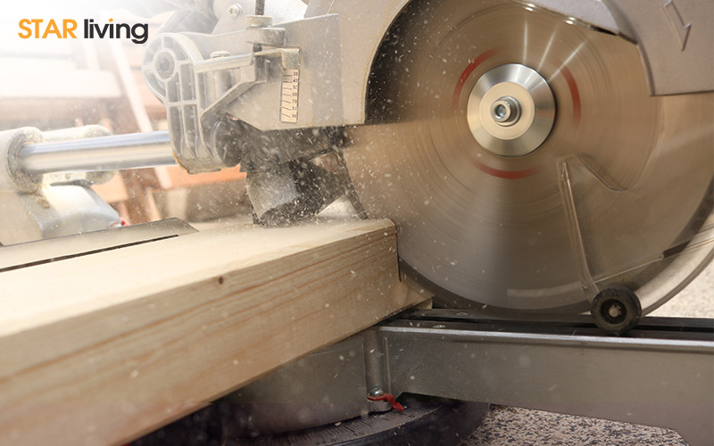 circular saw cutting through a wooden plank